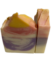 Load image into Gallery viewer, Organic cocoa butter, organic coconut oil, olive oil, shea butter, organic avocado oil, castor oil, aloe vera juice, vegan coconut milk powder, kaolin clay, vegan skin-safe colors, citric acid (natural preservative), cedarwood, bergamot, and lavender essential oils. Smells like spices with notes of Bergamot, Cedarwood, Zest and light undertone of Lavender. This bar is a gentle cleanser for all skin types.